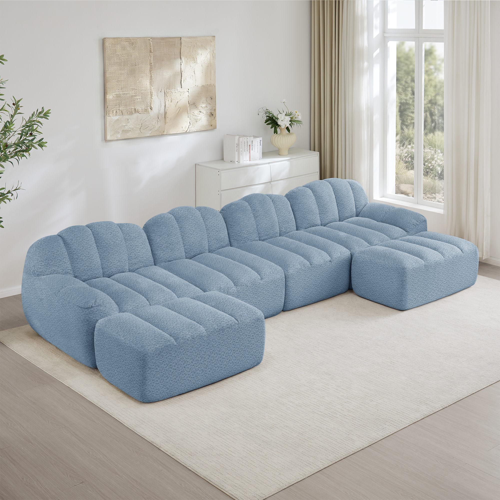 Canapé modulable panoramique 4 places en tissu granuleux bleu, structure sans pieds et design ergonomique pour grand salon