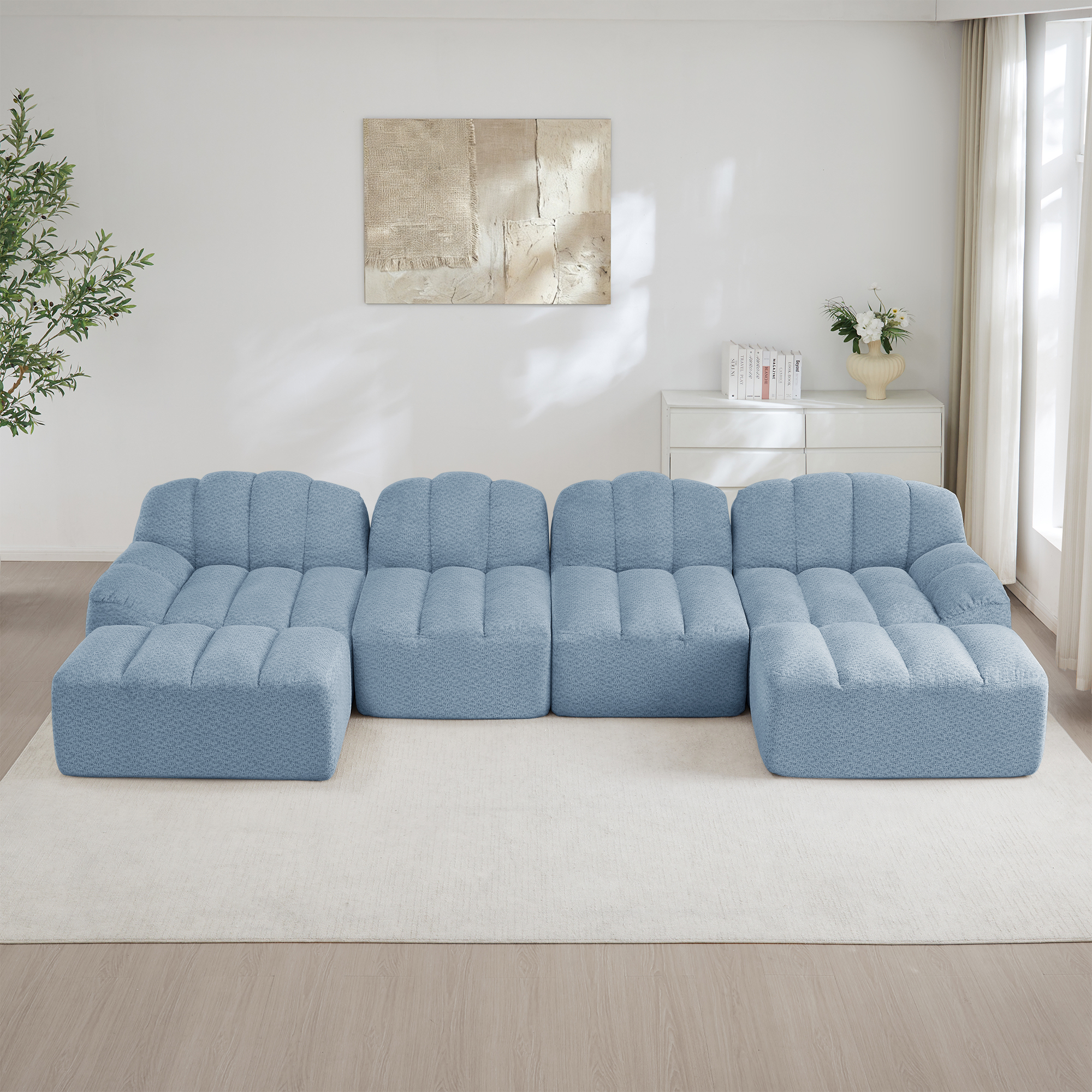 Canapé modulable panoramique 4 places en tissu granuleux bleu, structure sans pieds et design ergonomique pour grand salon