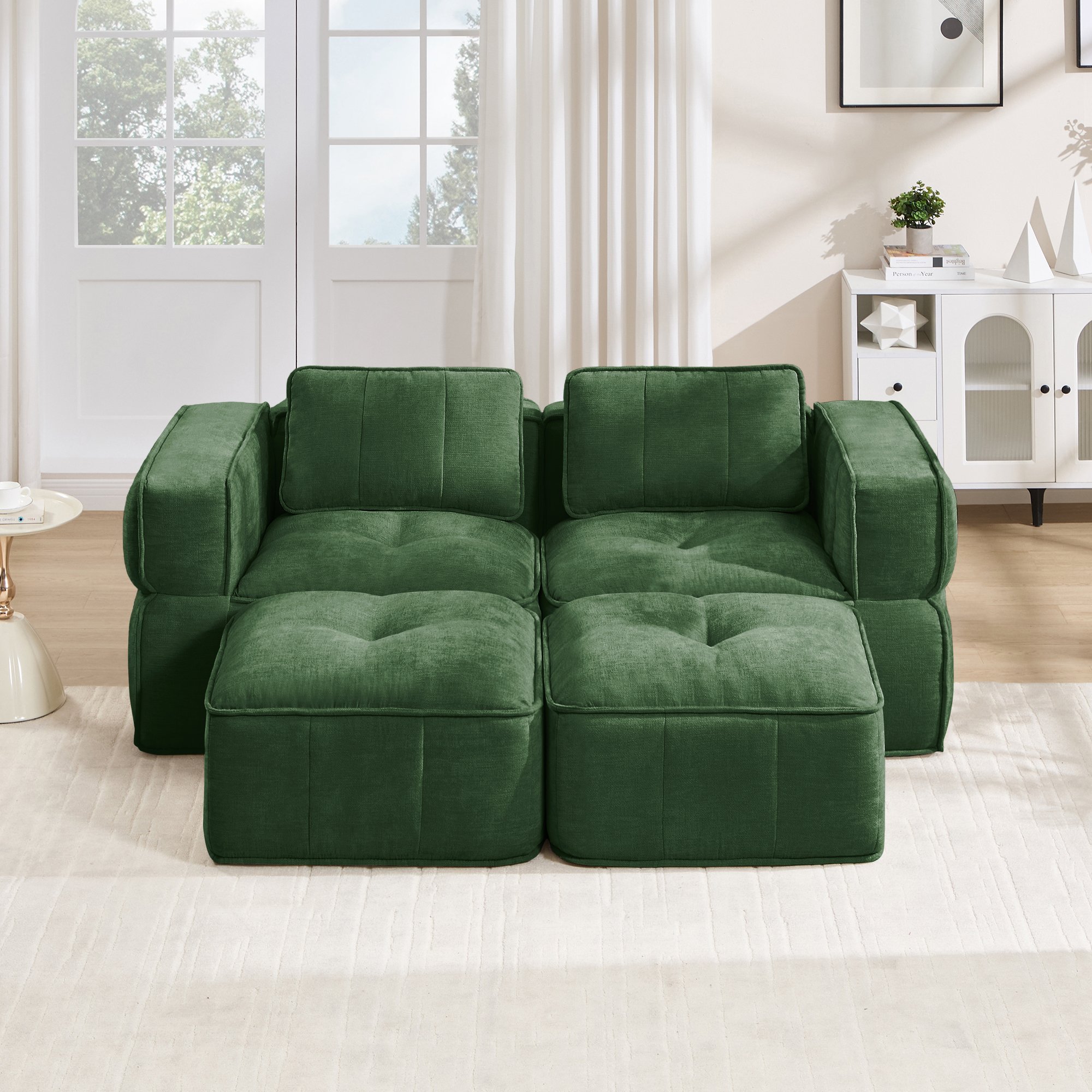 Canapé modulaire 2 places vert en polyester, sans structure, assise profonde et deux poufs inclus, idéal pour le salon moderne