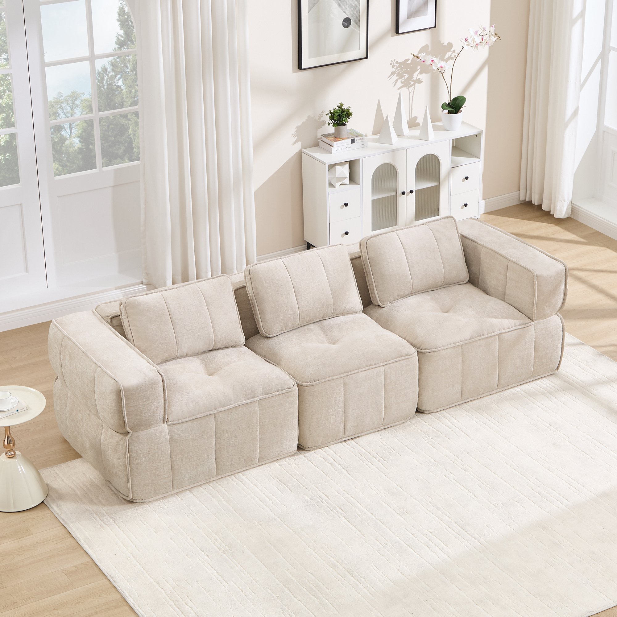 Canapé modulable 3 places beige en tissu polyester, design sans cadre avec mousse haute densité, dimensions 271x93x67 cm pour salon moderne et usage immédiat.