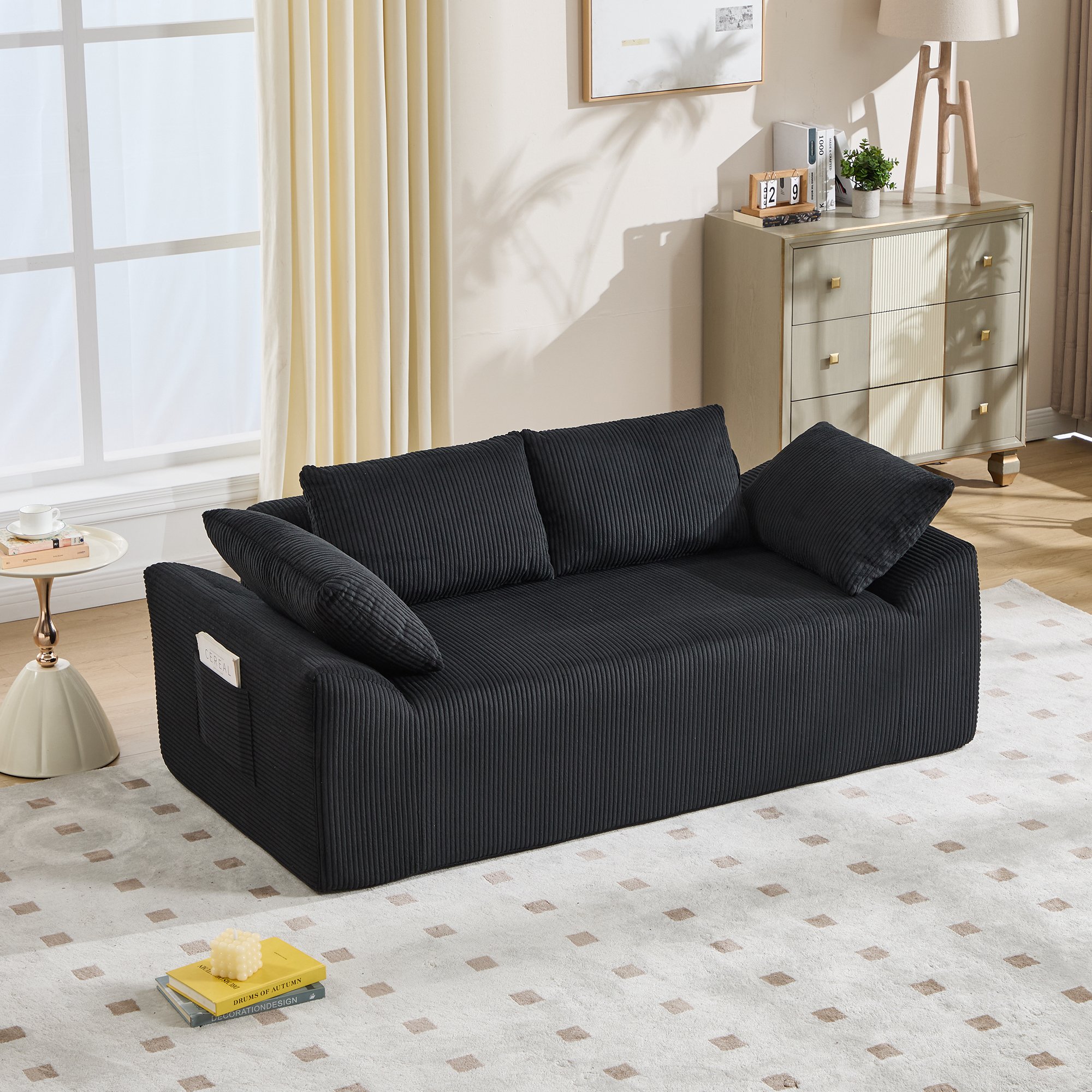 Canapé sans structure noir en tissu avec mousse à mémoire de forme, assise profonde et accoudoirs courbés, idéal pour petits espaces